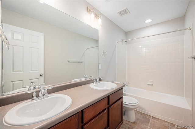 bathroom featuring a sink, bathing tub / shower combination, toilet, and visible vents