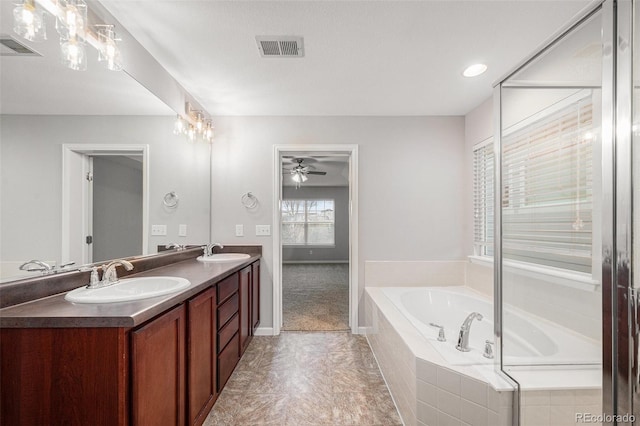 bathroom featuring a sink, ceiling fan, a garden tub, and visible vents