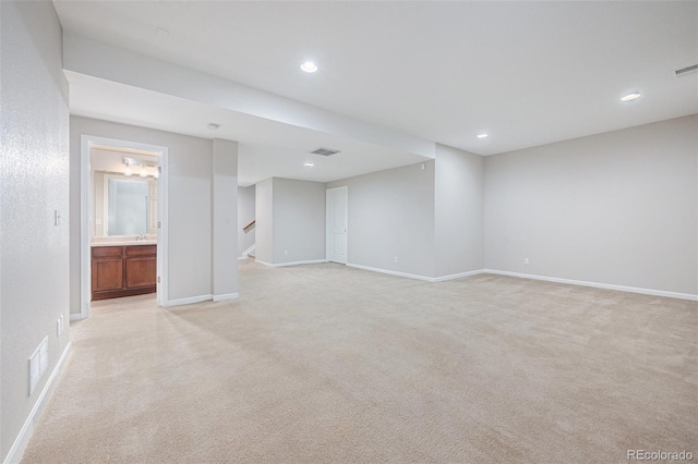 unfurnished room featuring light colored carpet, recessed lighting, baseboards, visible vents, and stairway