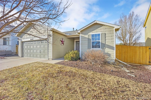 ranch-style home with a garage, concrete driveway, and fence