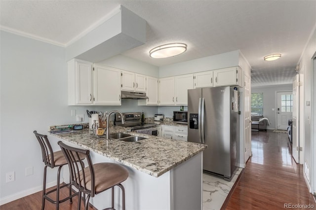 1622 S Idalia Cir Unit E, Aurora, CO 80017 - kitchen featuring stainless steel appliances, under cabinet range hood, a sink, a peninsula, and light stone counters