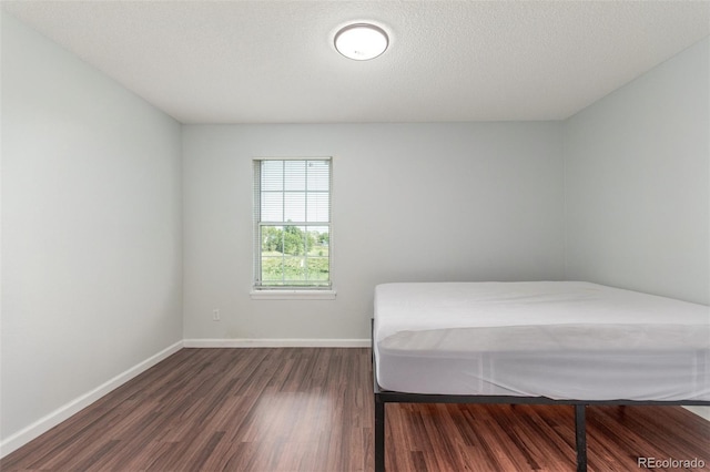 1622 S Idalia Cir Unit E, Aurora, CO 80017 - bedroom with dark wood-type flooring and baseboards