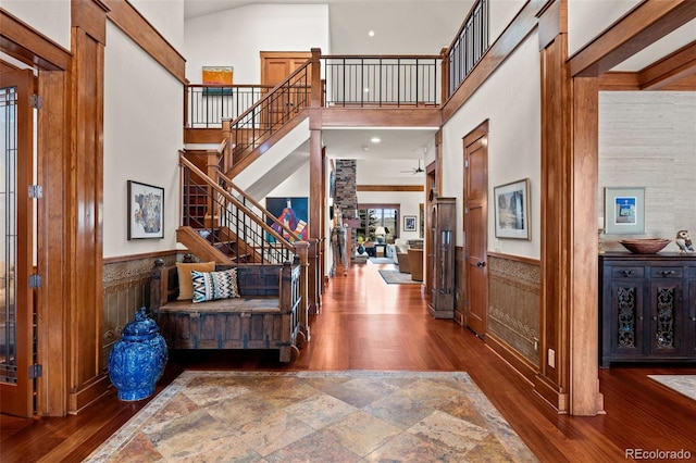 foyer entrance featuring hardwood / wood-style floors and a high ceiling