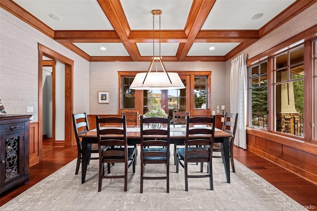 dining area featuring coffered ceiling, hardwood / wood-style floors, and beam ceiling