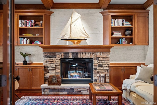 living room with beamed ceiling, hardwood / wood-style floors, and a fireplace