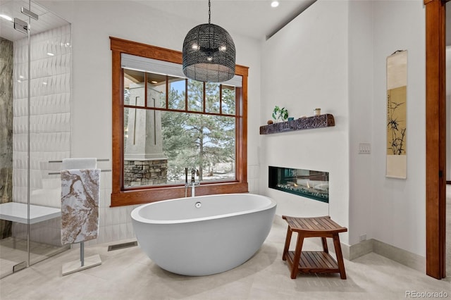 bathroom featuring shower with separate bathtub