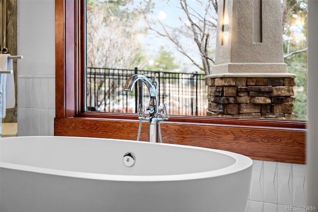 interior details featuring a washtub and sink