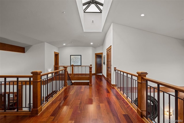 hallway with a skylight and dark hardwood / wood-style floors