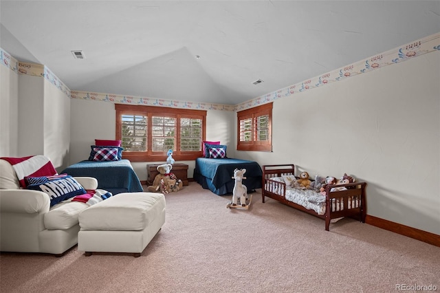 carpeted bedroom featuring a crib and vaulted ceiling