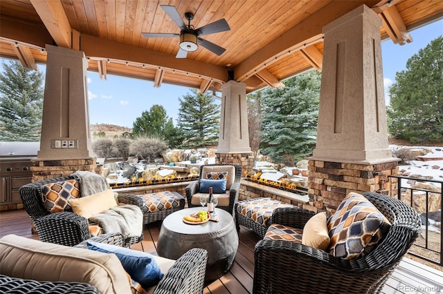 snow covered patio featuring ceiling fan and an outdoor hangout area