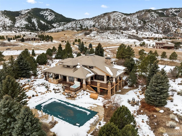 snowy aerial view featuring a mountain view