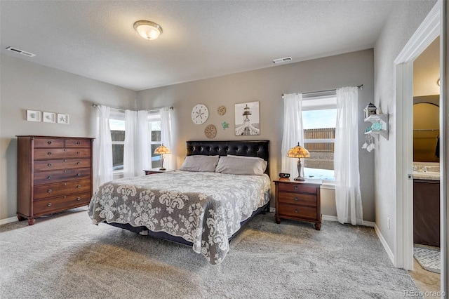 bedroom with carpet floors and a textured ceiling