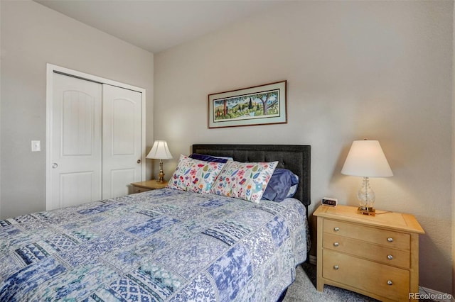 bedroom featuring light colored carpet and a closet