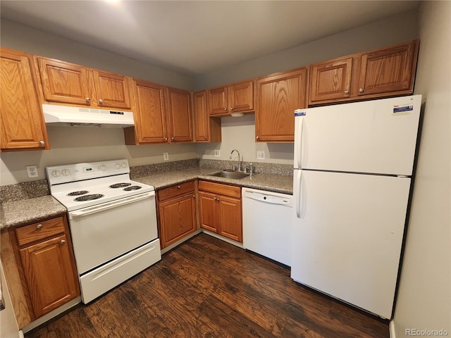 8330 Zuni St Unit 117, Denver, CO 80221 - kitchen with white appliances, under cabinet range hood, a sink, dark wood-style flooring, and brown cabinets