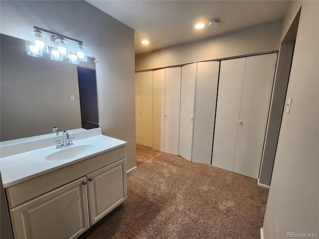 8330 Zuni St Unit 117, Denver, CO 80221 - bathroom featuring vanity, carpet, and recessed lighting