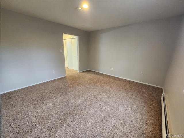 8330 Zuni St Unit 117, Denver, CO 80221 - empty room with carpet floors, baseboard heating, baseboards, and a smoke detector