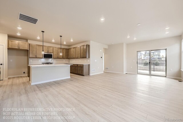 834 W 128th Pl, Westminster, CO 80234 - kitchen with decorative backsplash, light countertops, stainless steel microwave, visible vents, and recessed lighting