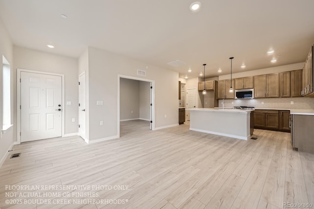 834 W 128th Pl, Westminster, CO 80234 - kitchen with light wood-style flooring, visible vents, recessed lighting, and stainless steel microwave