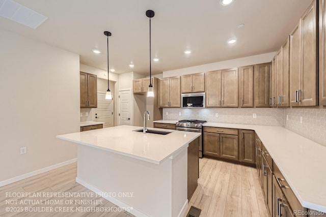 834 W 128th Pl, Westminster, CO 80234 - kitchen featuring visible vents, light wood finished floors, stainless steel appliances, and a sink