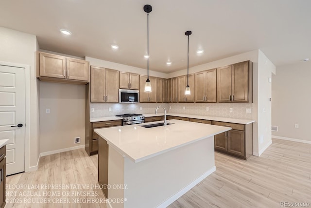 834 W 128th Pl, Westminster, CO 80234 - kitchen featuring stainless steel appliances, light countertops, a sink, and tasteful backsplash