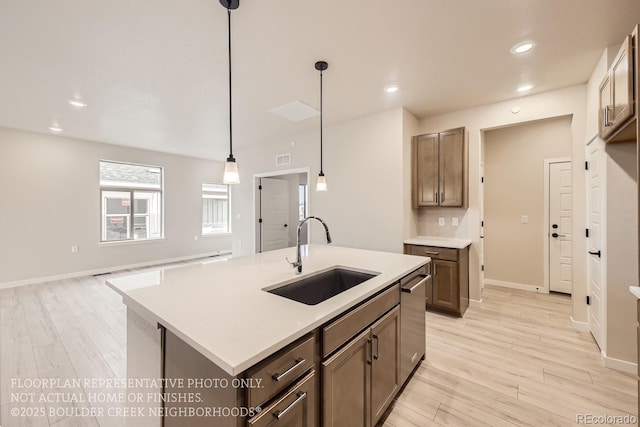 834 W 128th Pl, Westminster, CO 80234 - kitchen with stainless steel dishwasher, a sink, light wood-style floors, light countertops, and recessed lighting