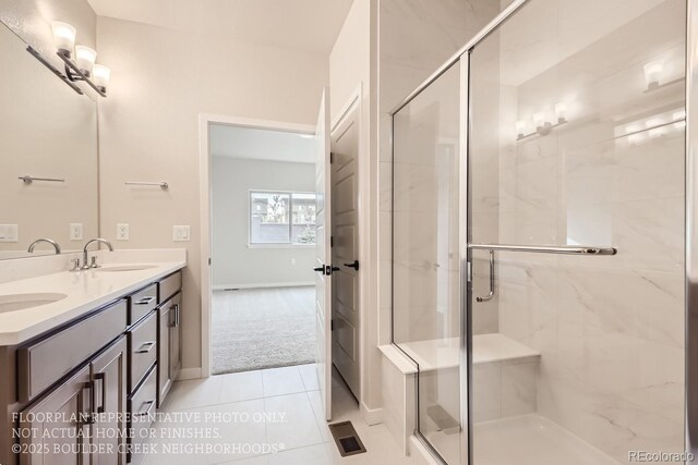 834 W 128th Pl, Westminster, CO 80234 - full bathroom with tile patterned floors, a sink, double vanity, a stall shower, and baseboards