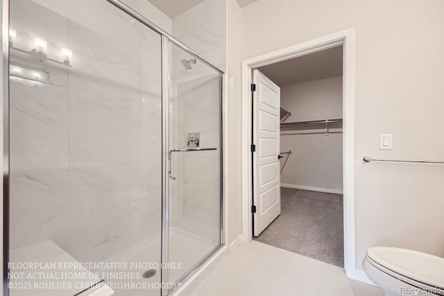834 W 128th Pl, Westminster, CO 80234 - bathroom with toilet, baseboards, a walk in closet, and a stall shower