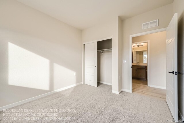 834 W 128th Pl, Westminster, CO 80234 - unfurnished bedroom with light carpet, a sink, baseboards, visible vents, and a closet