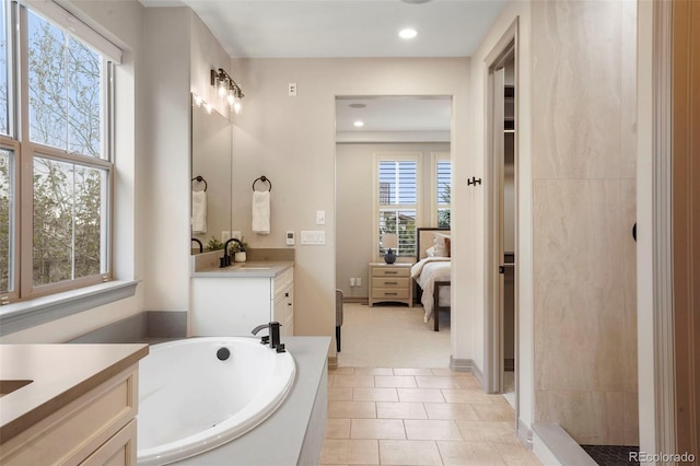 15252 W Warren Dr, Lakewood, CO 80228 - bathroom featuring a healthy amount of sunlight, vanity, a bath, and connected bathroom
