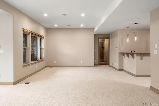 15252 W Warren Dr, Lakewood, CO 80228 - unfurnished living room with light colored carpet, recessed lighting, baseboards, and visible vents