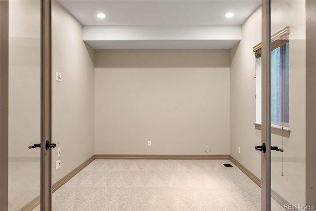 15252 W Warren Dr, Lakewood, CO 80228 - spare room with visible vents, baseboards, light carpet, and french doors