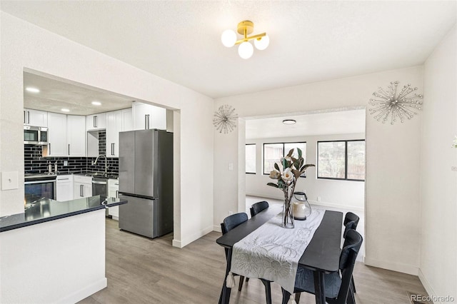206 Troy St, Aurora, CO 80011 - dining area featuring light wood-style floors and recessed lighting