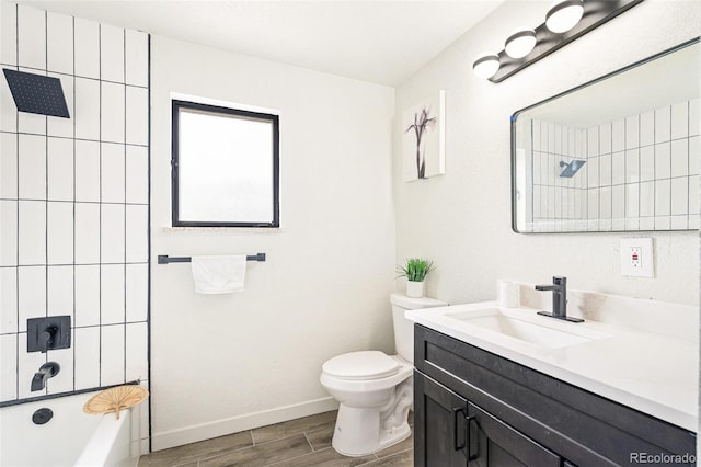 206 Troy St, Aurora, CO 80011 - full bathroom with vanity, wood finished floors, and  shower combination