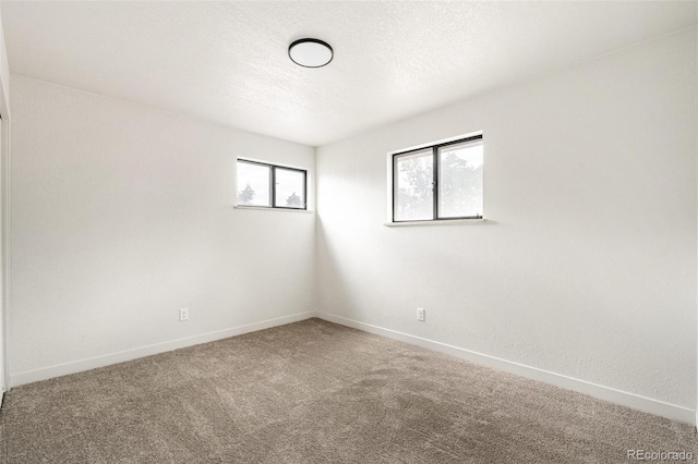 206 Troy St, Aurora, CO 80011 - empty room with carpet and a textured ceiling