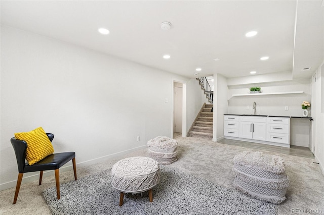 206 Troy St, Aurora, CO 80011 - sitting room featuring bar with sink, recessed lighting, stairway, and light colored carpet
