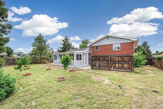 206 Troy St, Aurora, CO 80011 - back of house with a fenced backyard and brick siding