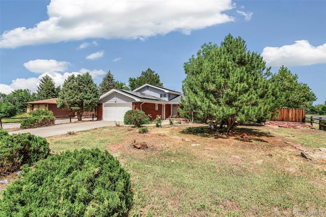 206 Troy St, Aurora, CO 80011 - view of front of home with a garage, concrete driveway, roof mounted solar panels, and brick siding