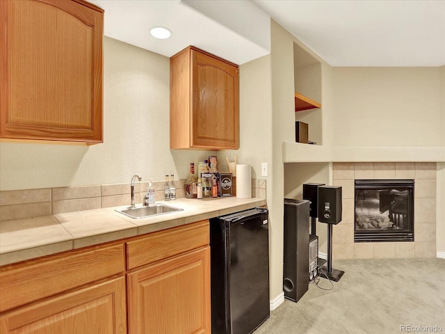 11556 W Cooper Pl, Littleton, CO 80127 - kitchen featuring light colored carpet, black fridge, a fireplace, and open shelves