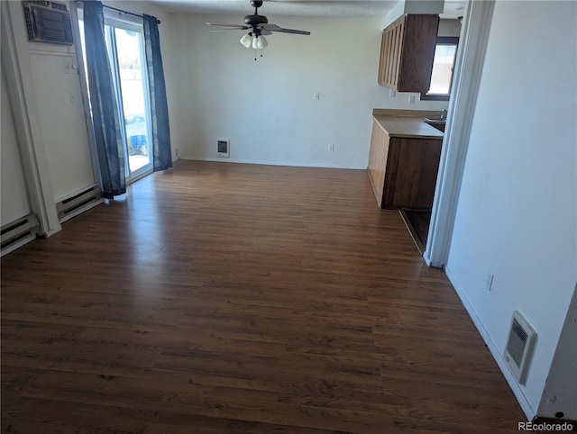 interior space with visible vents, dark wood finished floors, and a wealth of natural light