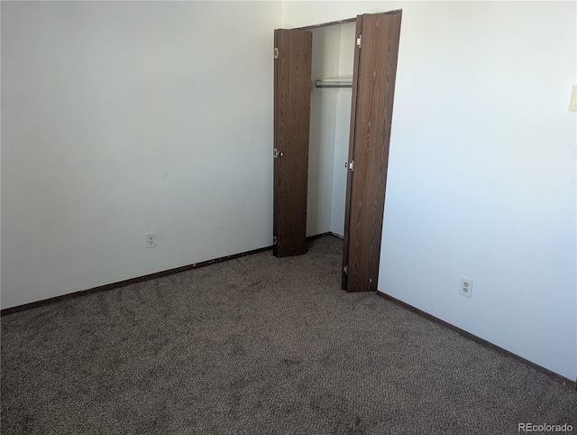 carpeted empty room with baseboards