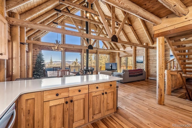 kitchen with wood ceiling, light wood-style flooring, open floor plan, beamed ceiling, and stainless steel dishwasher