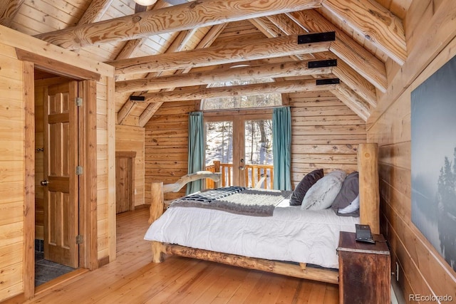 bedroom with french doors, vaulted ceiling with beams, wood ceiling, wooden walls, and hardwood / wood-style floors