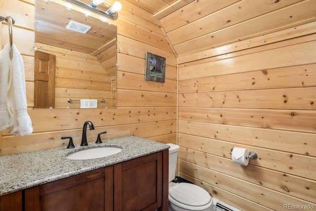 bathroom with wooden ceiling, vanity, toilet, and wooden walls