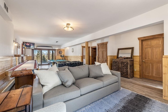 living area featuring billiards, visible vents, wainscoting, wood finished floors, and wood walls