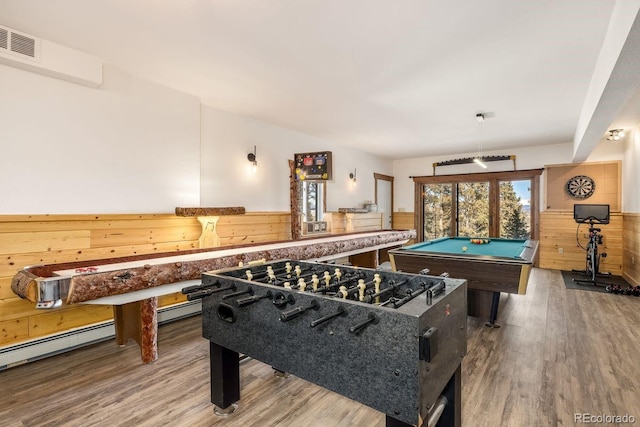 rec room with wood walls, wainscoting, wood finished floors, and visible vents