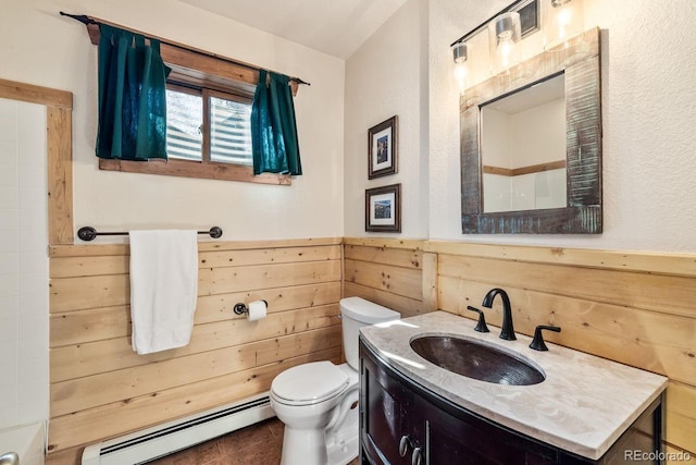 bathroom featuring a baseboard radiator, toilet, wainscoting, wooden walls, and vanity