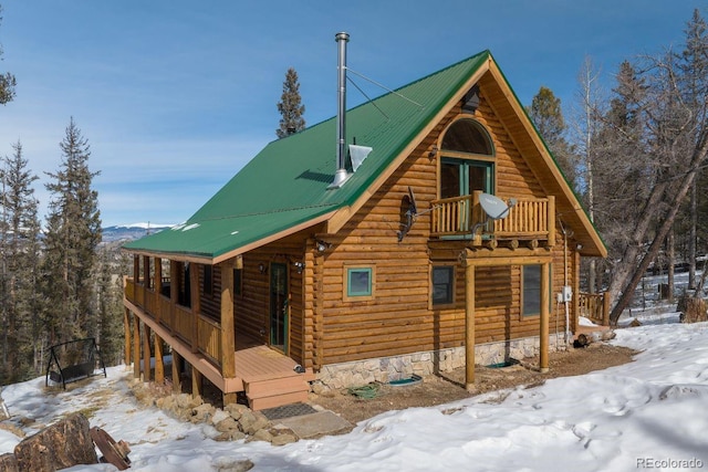 exterior space featuring covered porch and metal roof