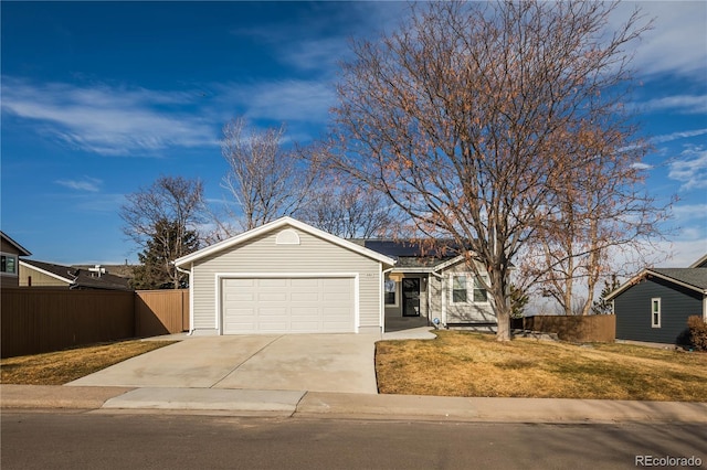 ranch-style home featuring a garage and a front lawn