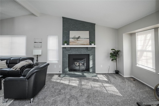 carpeted living room with vaulted ceiling with beams and a fireplace