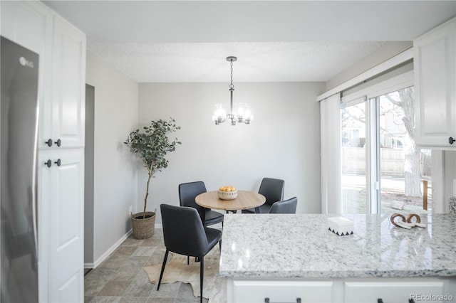 dining area with a notable chandelier and a textured ceiling